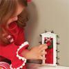 Standing miniature dimensional door surrounded with “lights” and tiny faux wreath with bow allows special entry for fairies and elves