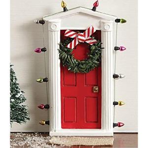 Standing miniature dimensional door surrounded with “lights” and tiny faux wreath with bow allows special entry for fairies and elves